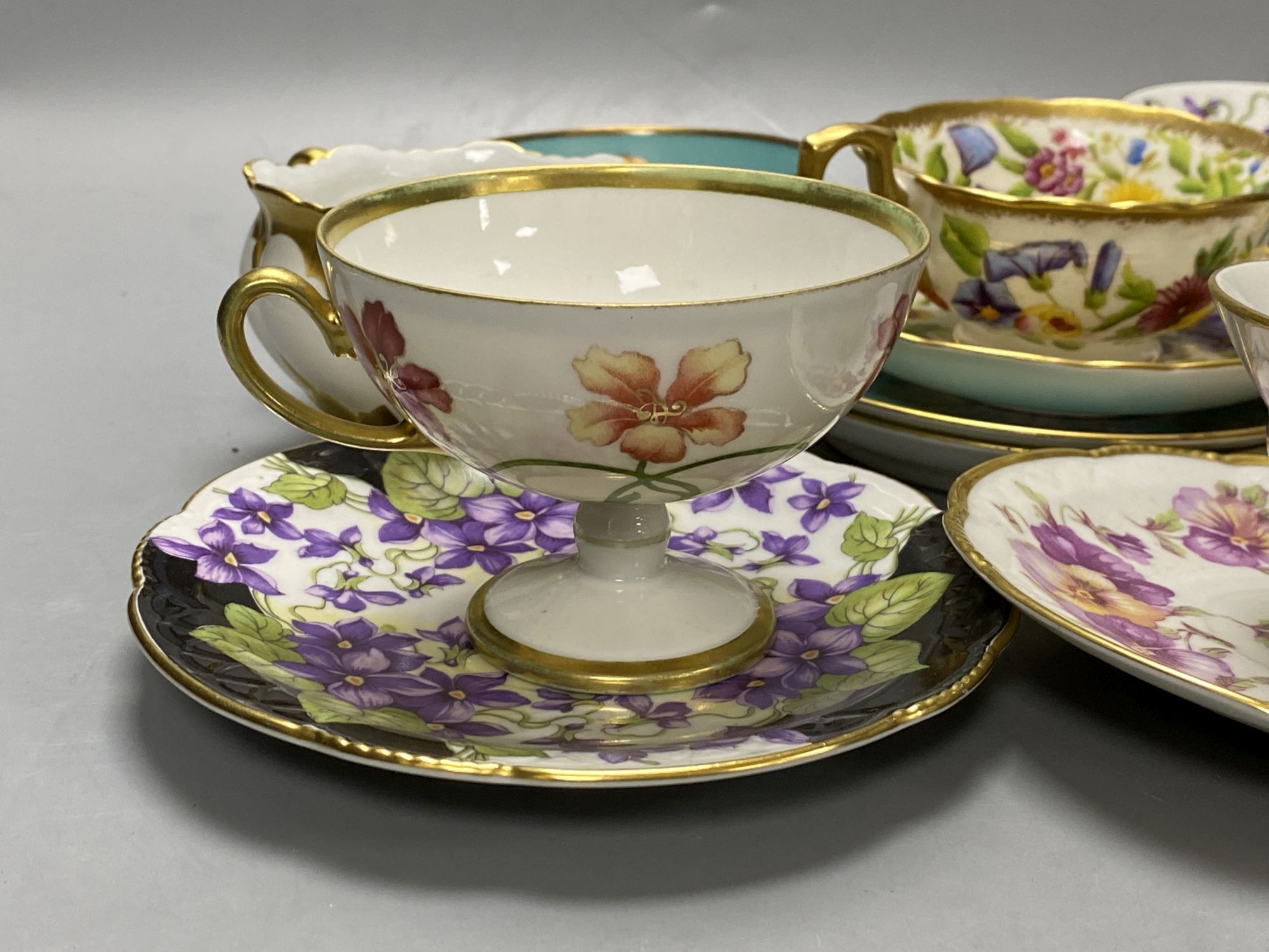 A collection of Continental porcelain tea cups and saucers